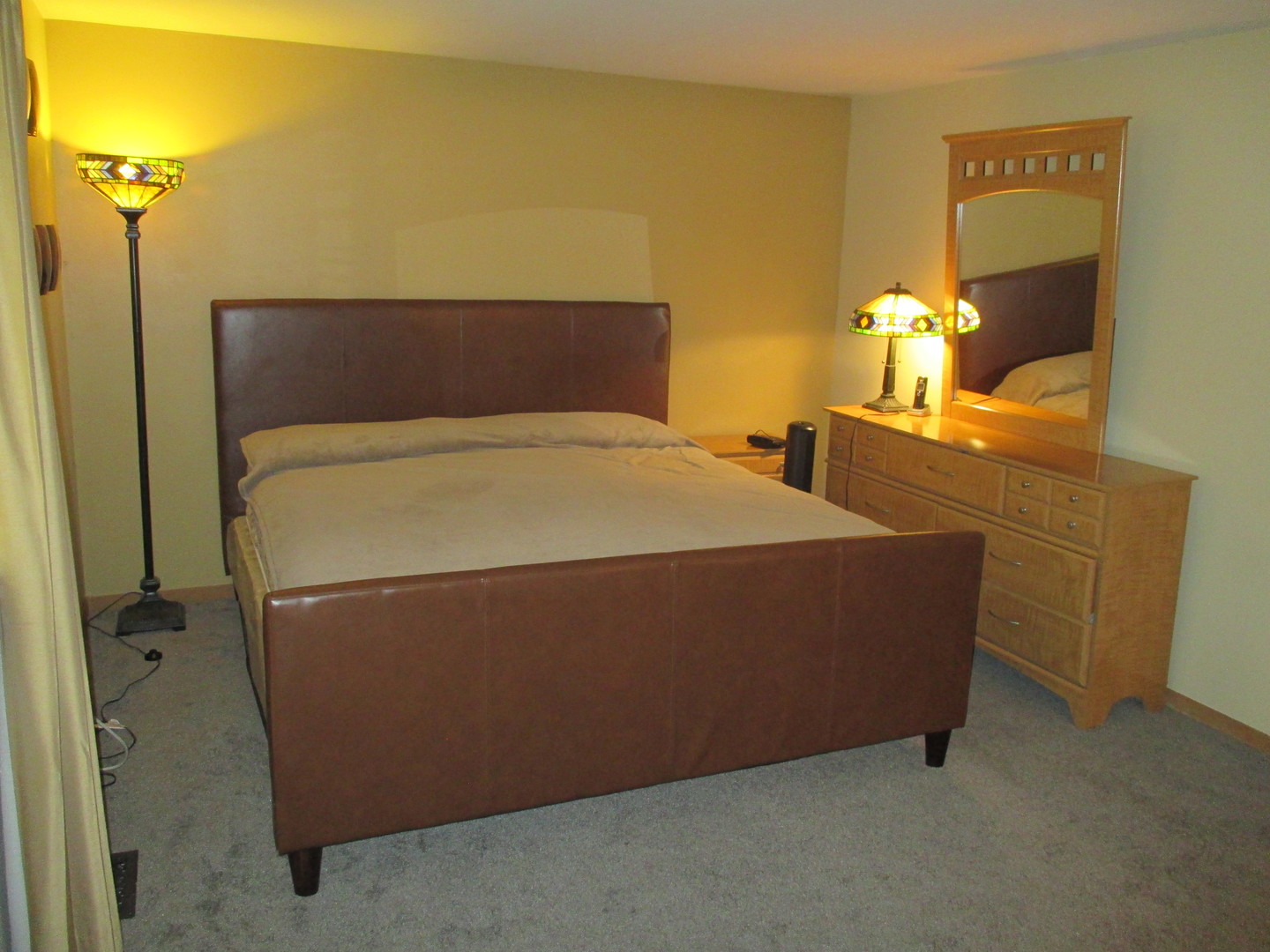 30W261 Mack Road Warrenville, IL 60555 - Photo 17 of 28 a bed sitting in a room next to a lamp