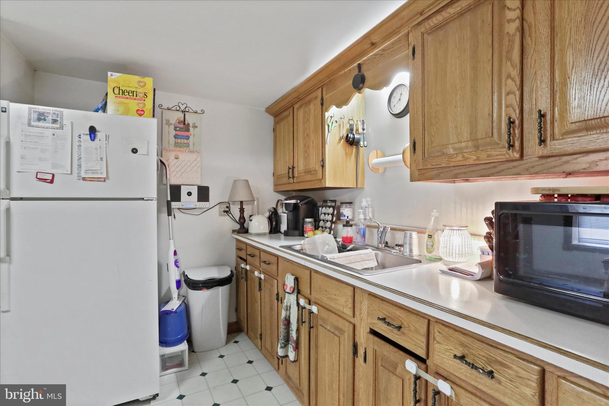20 East Madison Street Greencastle, PA 17225 - Photo 25 of 36 a kitchen with a refrigerator a sink and wooden cabinets