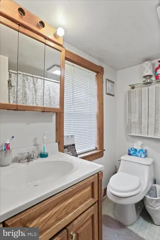 a bathroom with a toilet and a shower curtain