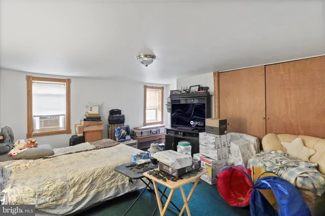 a bedroom with two beds and a couch