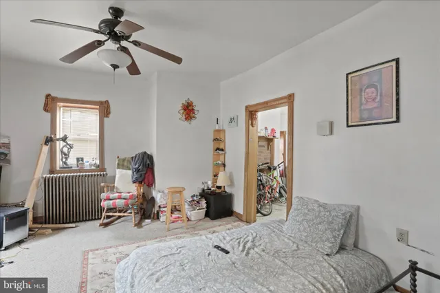 a bedroom with bed and a chandelier