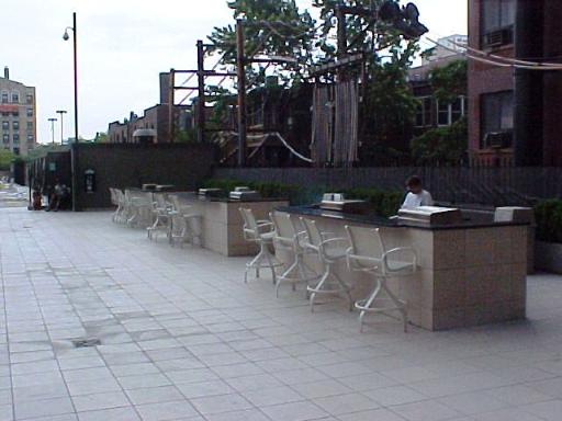 655 West Irving Park Road, Unit 4413 Chicago, IL 60613 - Photo 10 of 11 a view of a patio with table and chairs with wooden fence