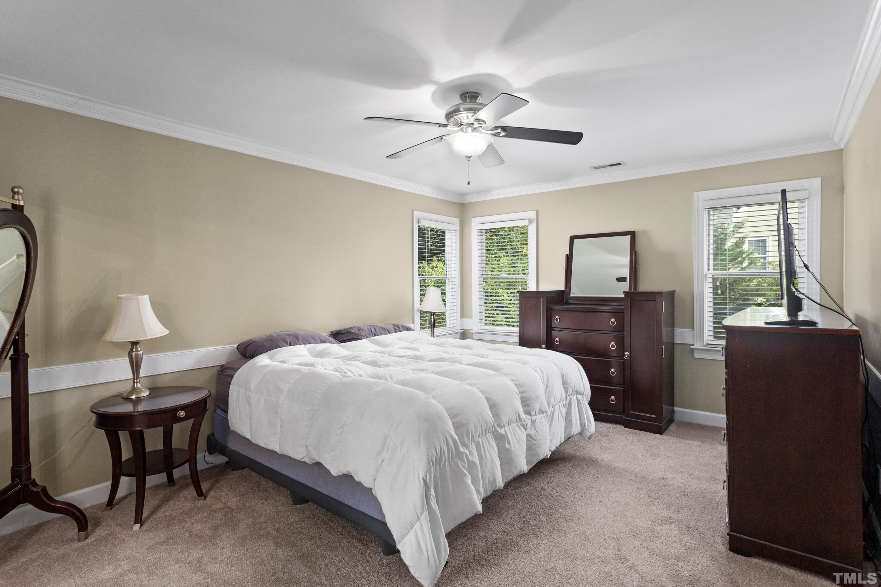 2933 Dahlgreen Road Raleigh, NC 27615 - Photo 14 of 31 a bedroom with a bed and a chandelier