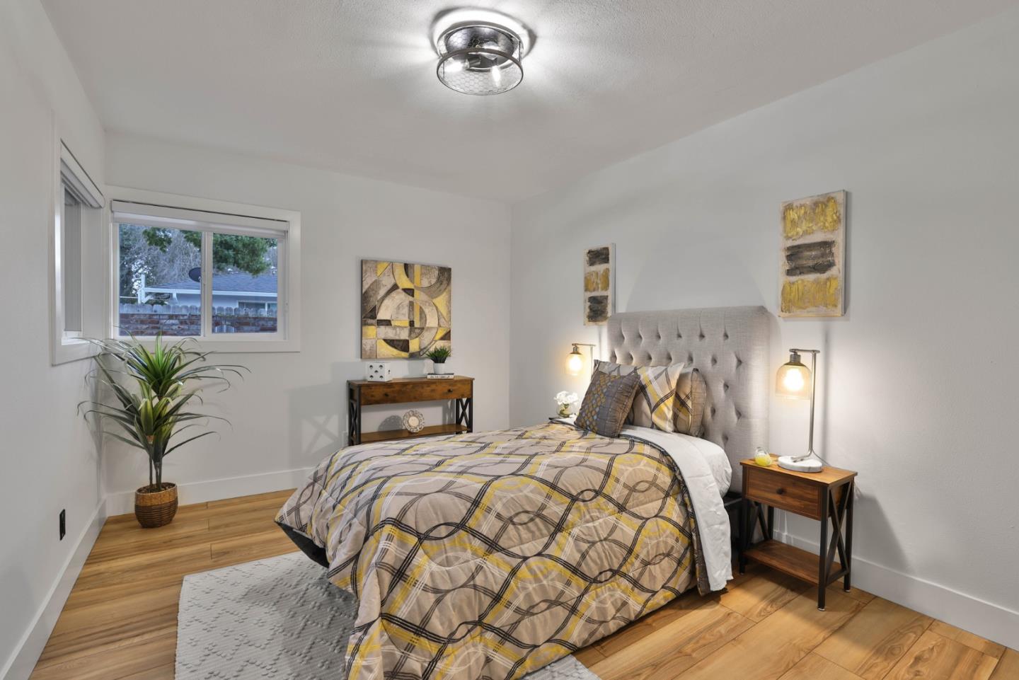 1280 Burrows Road Campbell, CA 95008 - Photo 20 of 47 a bedroom with a bed and a chandelier