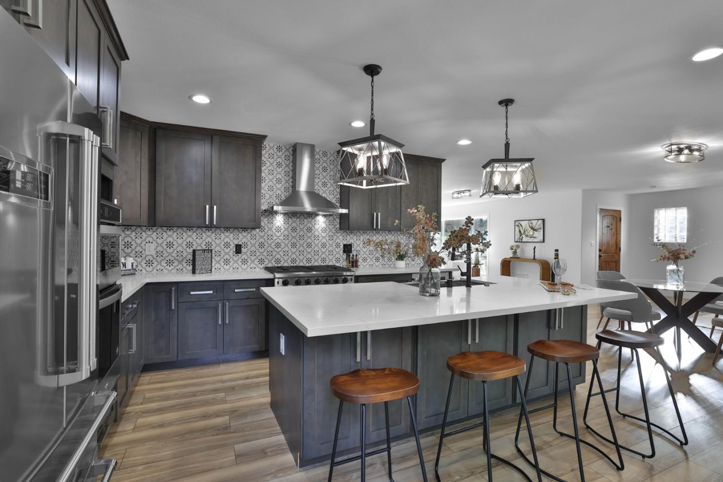 1280 Burrows Road Campbell, CA 95008 - Photo 6 of 47 a kitchen with stainless steel appliances kitchen island granite countertop a sink a stove a refrigerator and island with wooden floor