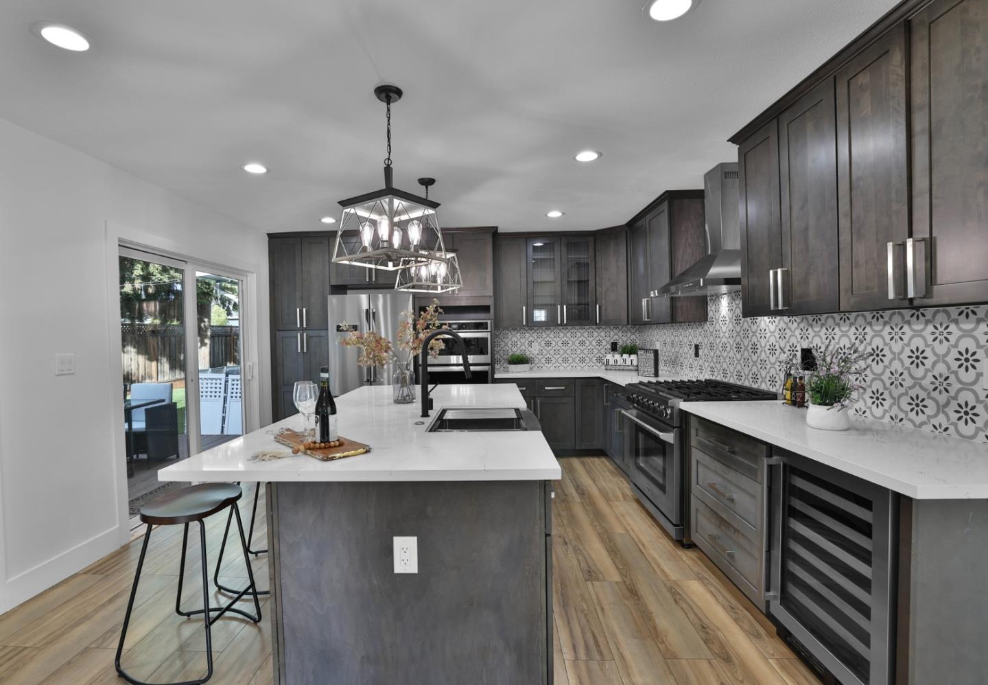 1280 Burrows Road Campbell, CA 95008 - Photo 7 of 47 a kitchen with kitchen island granite countertop a sink a counter space appliances and cabinets