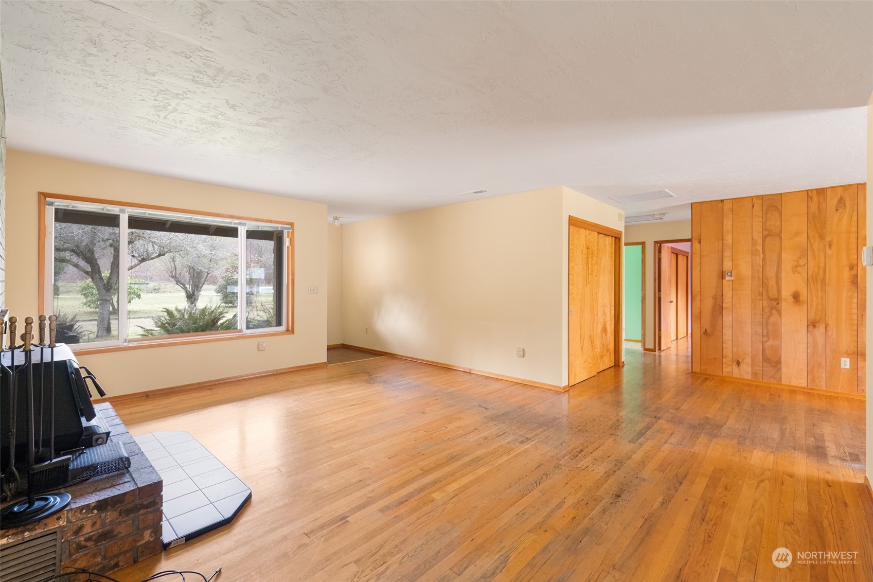 521 Robertson Road Longview, WA 98632 - Photo 7 of 40 a view of an empty room with wooden floor and a window