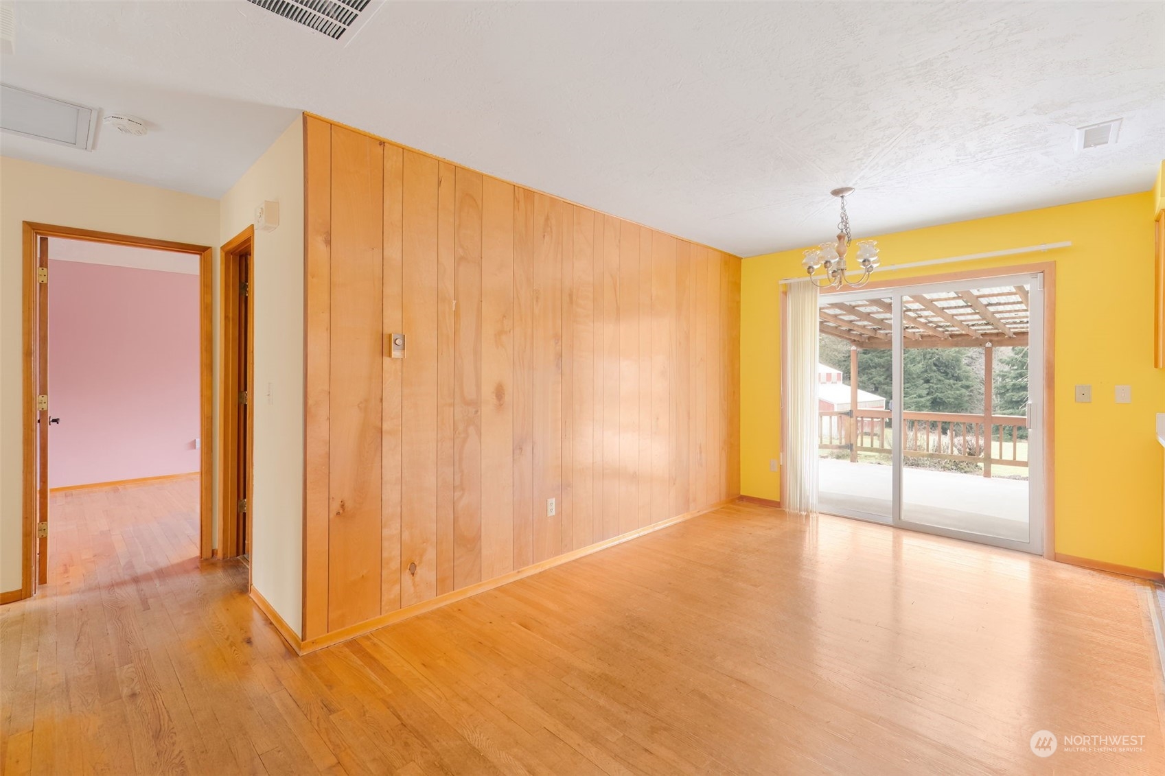 521 Robertson Road Longview, WA 98632 - Photo 8 of 40 a view of an empty room with wooden floor and a window