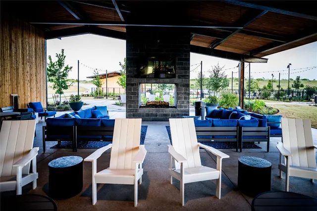 a view of a patio with couches chairs and potted plants