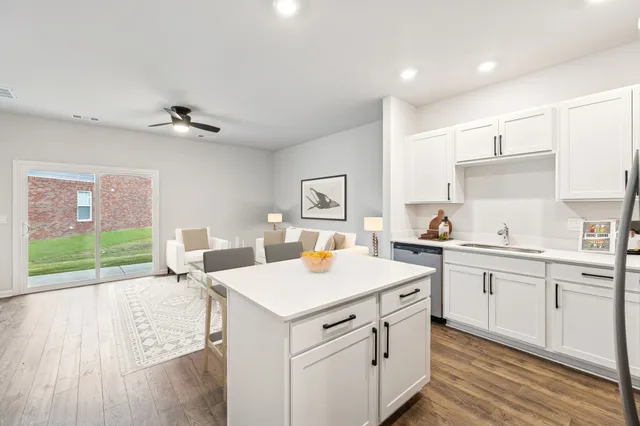 a kitchen with a refrigerator sink and cabinets