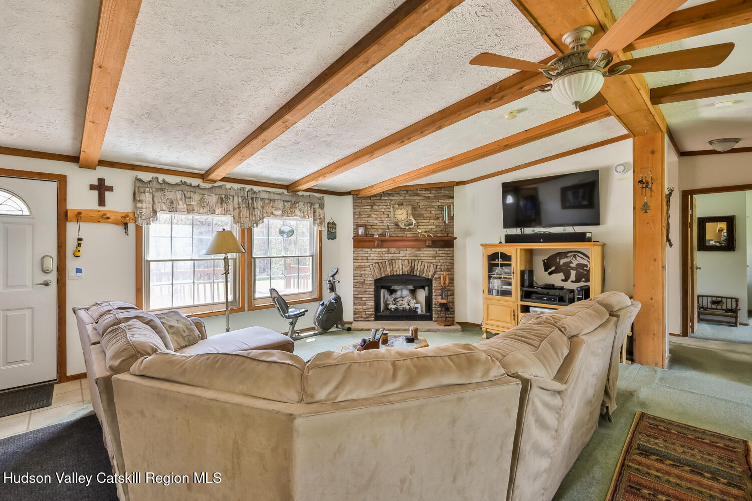 751 Mitchell Hollow Road Windham, NY 12496 - Photo 12 of 37 a living room with fireplace furniture and a flat screen tv
