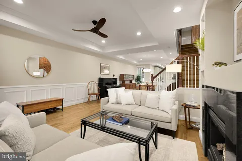a living room with furniture and kitchen view