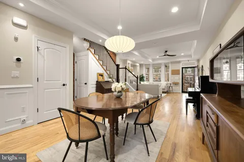a view of a dining room with furniture and wooden floor
