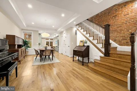 a dining room with furniture and wooden floor