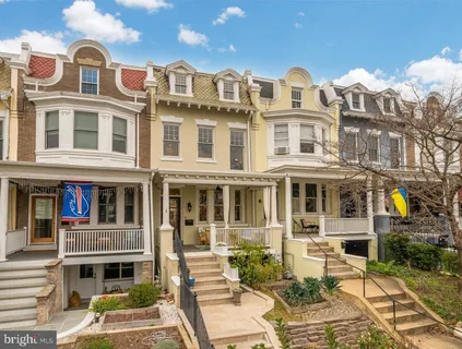 a front view of a residential apartment building with a yard