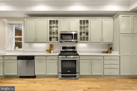 a kitchen with granite countertop a stove and a sink
