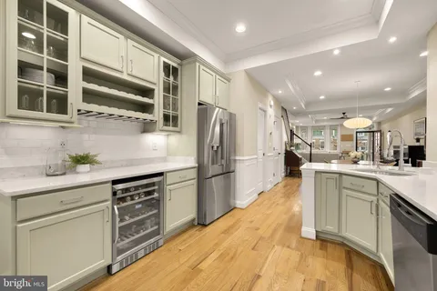 a kitchen with stainless steel appliances a refrigerator sink and cabinets