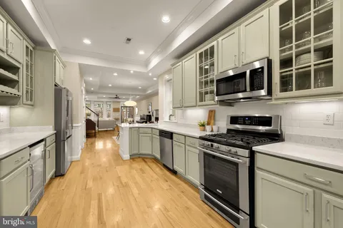 a kitchen with stainless steel appliances granite countertop a stove and a sink