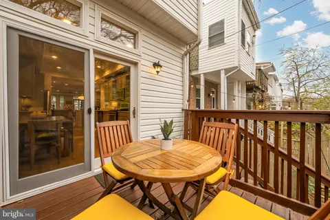 a view of a balcony with a table and chairs