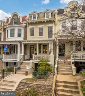 a front view of a residential apartment building with a yard