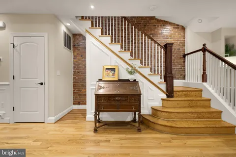 a spacious bedroom with a bed and wooden floor