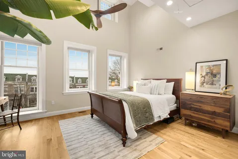 a bedroom with a bed and a chandelier