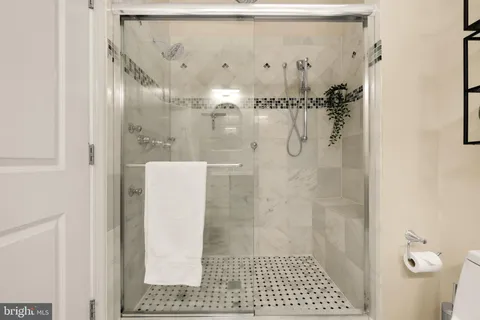 a living room with furniture and painting on the wall