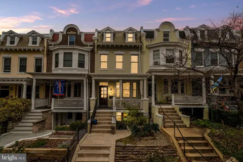 a front view of a residential apartment building with a yard