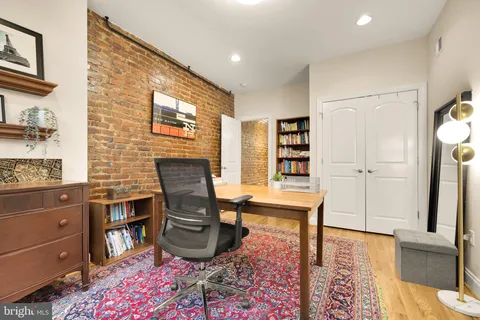 a living room with furniture a rug and a window