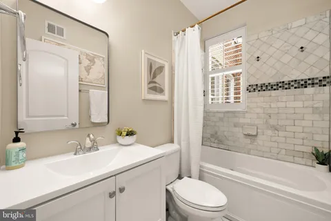 a kitchen with stainless steel appliances kitchen island granite countertop a refrigerator and a stove top oven