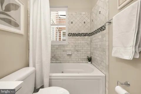 a kitchen with stainless steel appliances kitchen island granite countertop a sink and a refrigerator