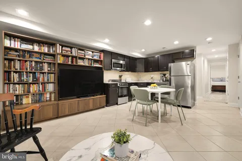 a bedroom with two beds and painting on the wall