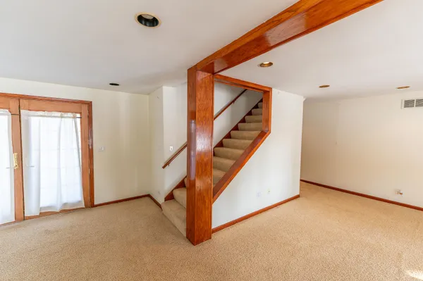 a bedroom with a bed and painting on the wall