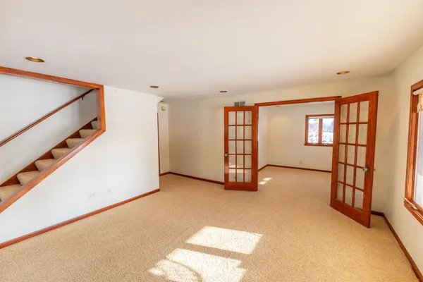 a view of an empty room and window and fire place