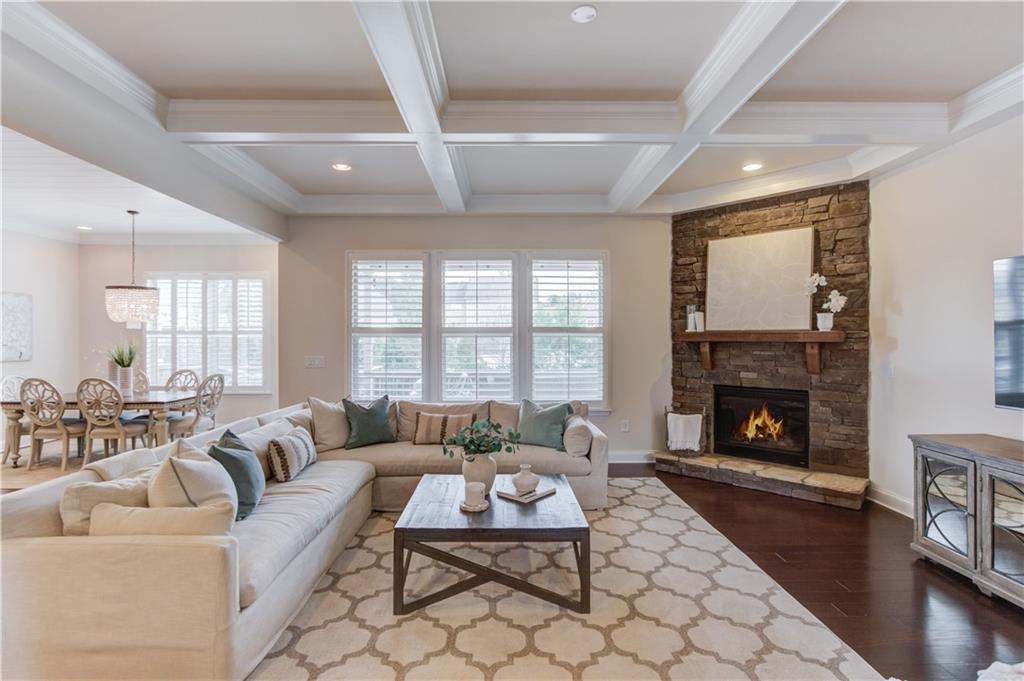 632 Rio Vista Court Suwanee, GA 30024 - Photo 12 of 64 a living room with furniture a fireplace with wooden floor