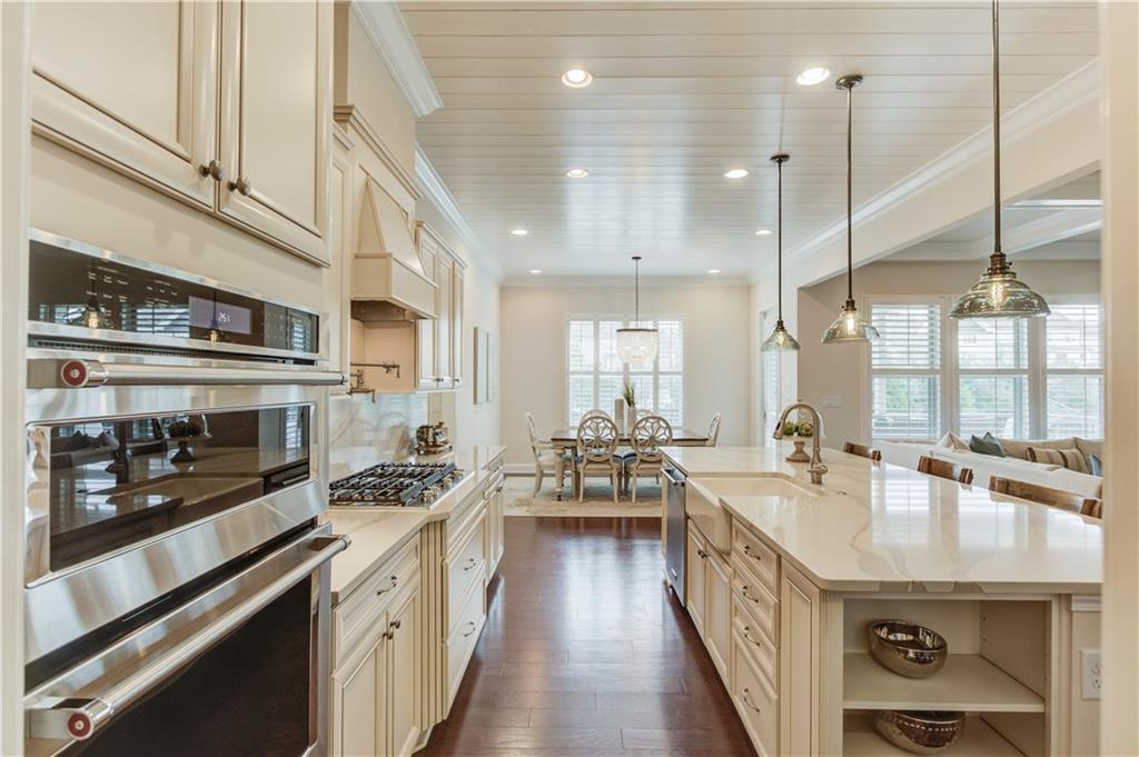 632 Rio Vista Court Suwanee, GA 30024 - Photo 17 of 64 a kitchen with stainless steel appliances a sink a stove and a wooden floor