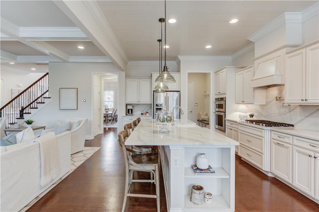 632 Rio Vista Court Suwanee, GA 30024 - Photo 19 of 64 a large kitchen with kitchen island a stove a sink a center island and a cabinets