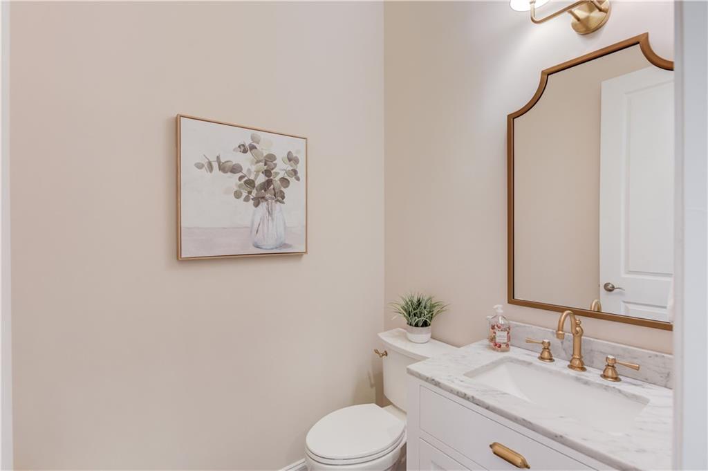 632 Rio Vista Court Suwanee, GA 30024 - Photo 23 of 64 a bathroom with a toilet sink and mirror