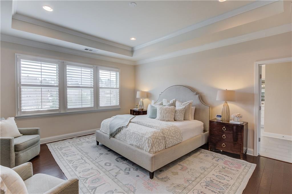 632 Rio Vista Court Suwanee, GA 30024 - Photo 32 of 64 a bedroom with a large bed and a couch