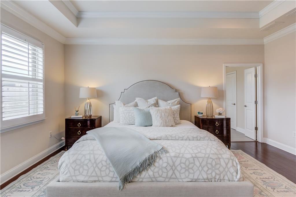 632 Rio Vista Court Suwanee, GA 30024 - Photo 33 of 64 a bedroom with a bed and wooden floor