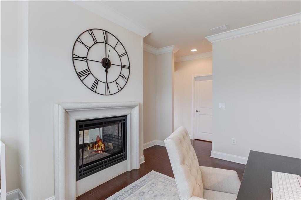 632 Rio Vista Court Suwanee, GA 30024 - Photo 36 of 64 a living room with furniture a fireplace and a window