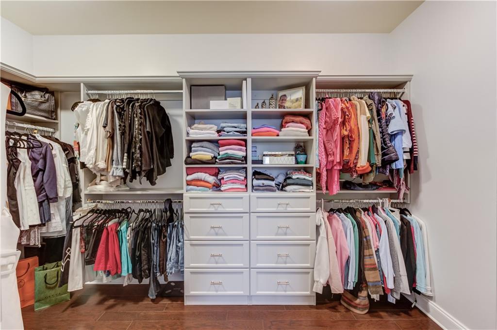 632 Rio Vista Court Suwanee, GA 30024 - Photo 37 of 64 a view of walk in closet with clothes and shoes