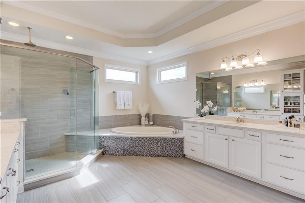 632 Rio Vista Court Suwanee, GA 30024 - Photo 39 of 64 a spacious bathroom with a bathtub shower sink double and mirror