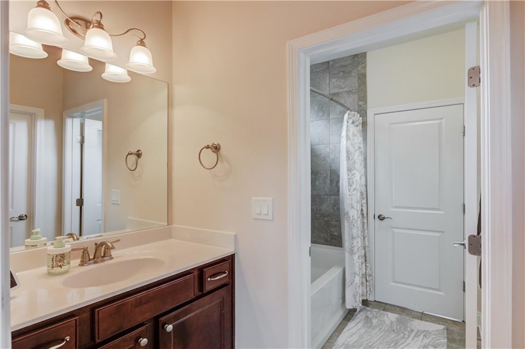 632 Rio Vista Court Suwanee, GA 30024 - Photo 46 of 64 a bathroom with a sink vanity and a mirror
