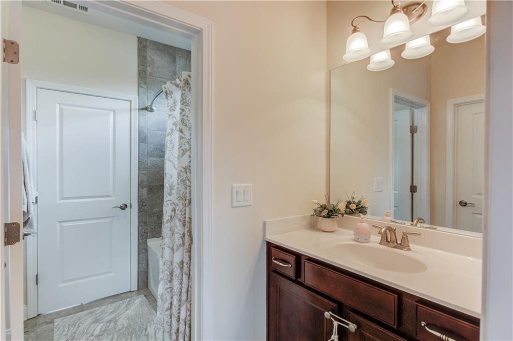 632 Rio Vista Court Suwanee, GA 30024 - Photo 47 of 64 a bathroom with a sink vanity and a mirror