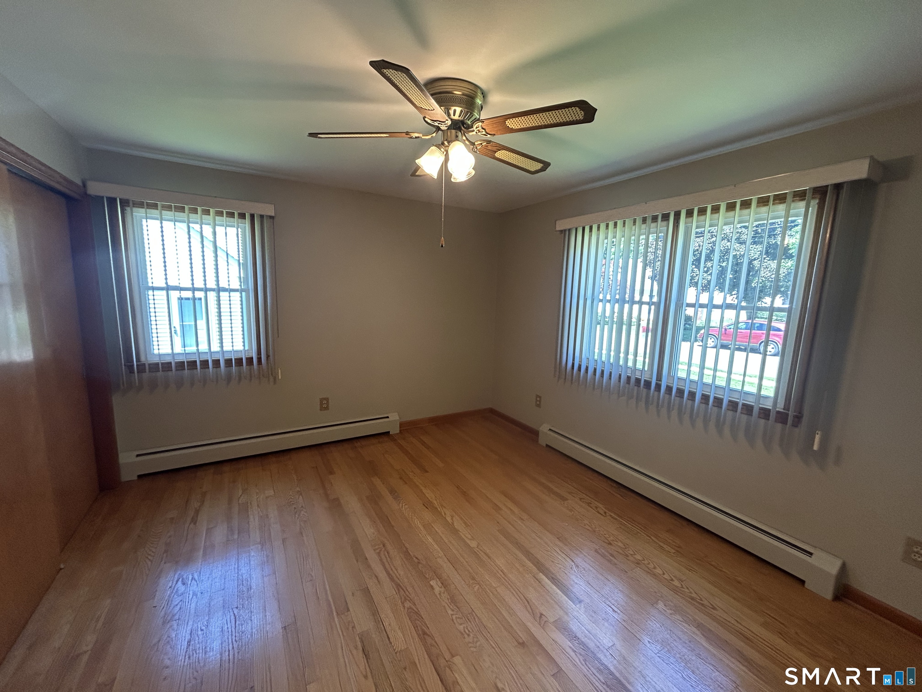 13 Walnut Lane Wallingford, CT 06492 - Photo 13 of 27 a view of an empty room with wooden floor and a window