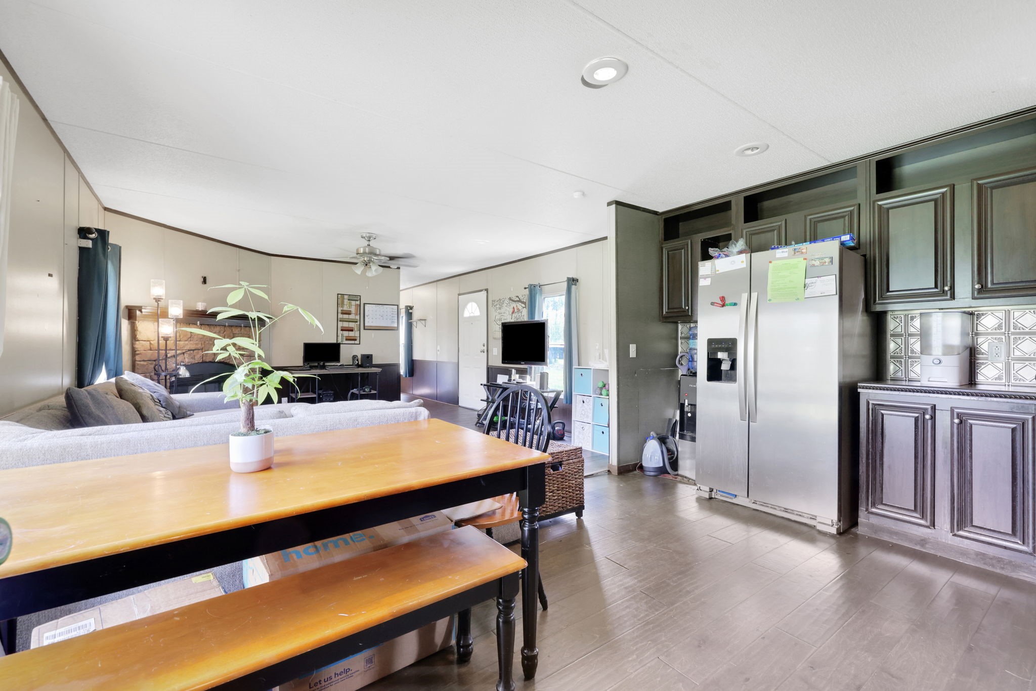 103 Sunset Lane Somerville, TX 77879 - Photo 12 of 43 a room with stainless steel appliances a dining table chairs refrigerator and sink