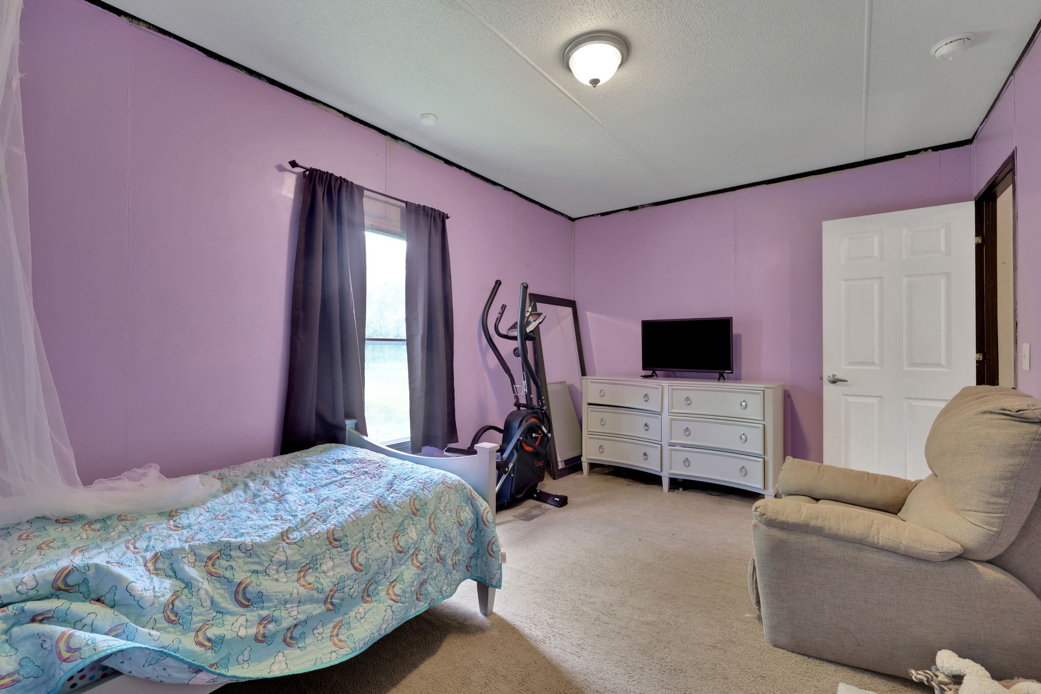 103 Sunset Lane Somerville, TX 77879 - Photo 16 of 42 a bedroom with a bed and a flat screen tv