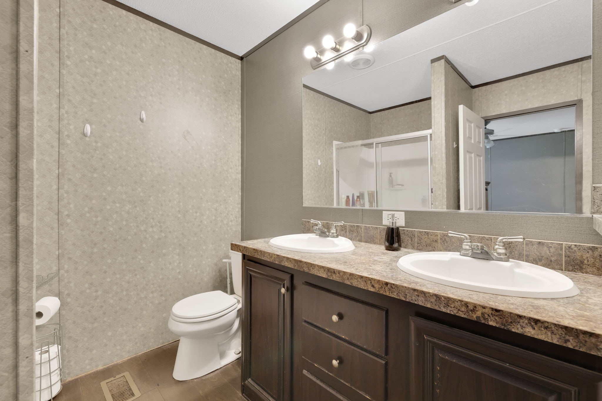 103 Sunset Lane Somerville, TX 77879 - Photo 20 of 43 a bathroom with a granite countertop sink a toilet and a mirror