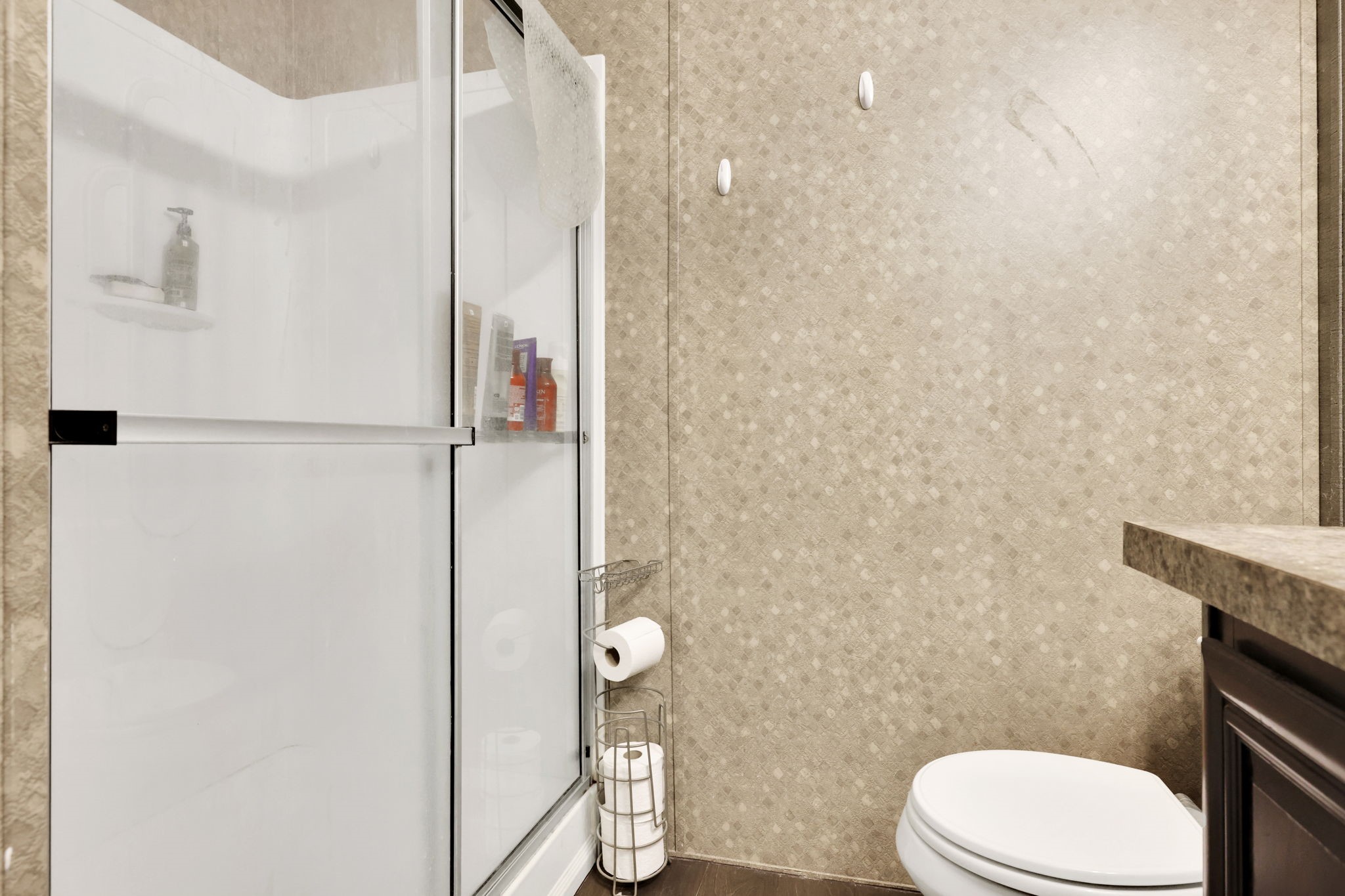 103 Sunset Lane Somerville, TX 77879 - Photo 22 of 42 a white toilet sitting next to a bathroom sink